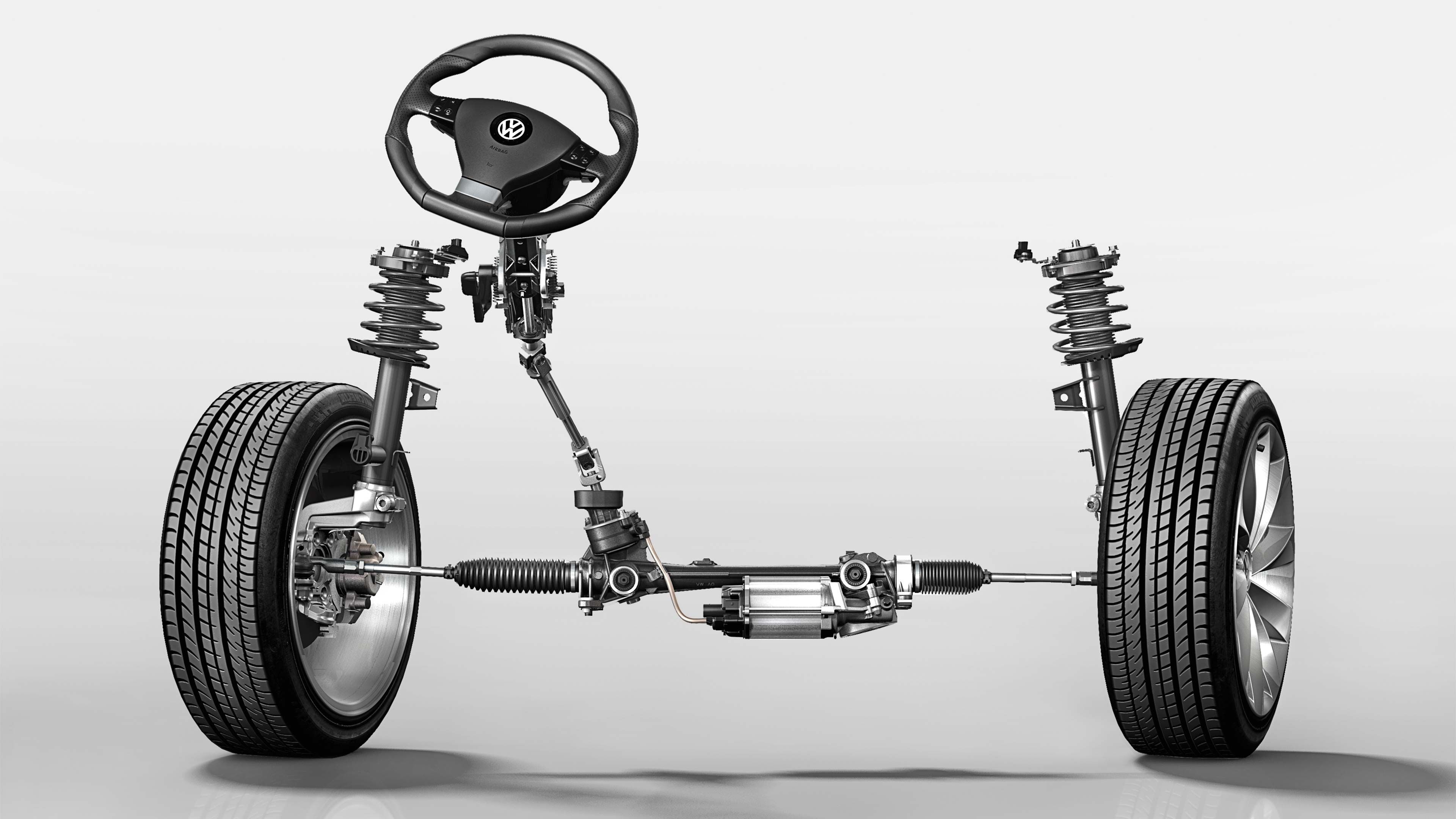 Ilustrácia zavesenia predných kolies automobilu s volantom, tlmičmi, riadením a posilňovačom. Hlavné komponenty sú zvýraznené na svetlom pozadí. Zobrazená väčšina mechanických častí bez karosérie.