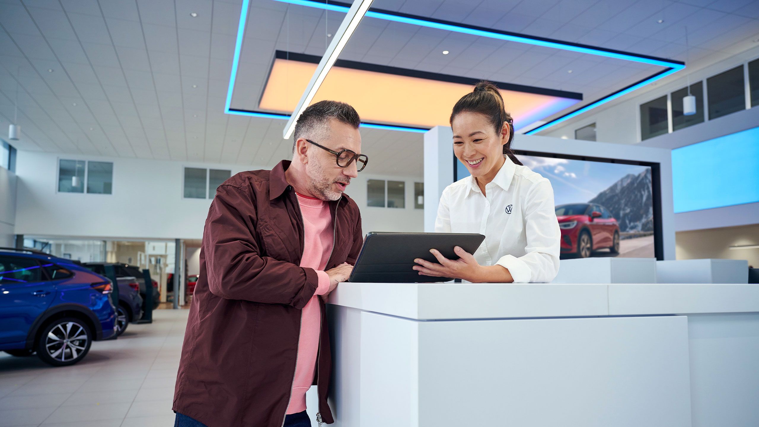 Zamestnanec servisu VW informuje zákazníka na tablete
