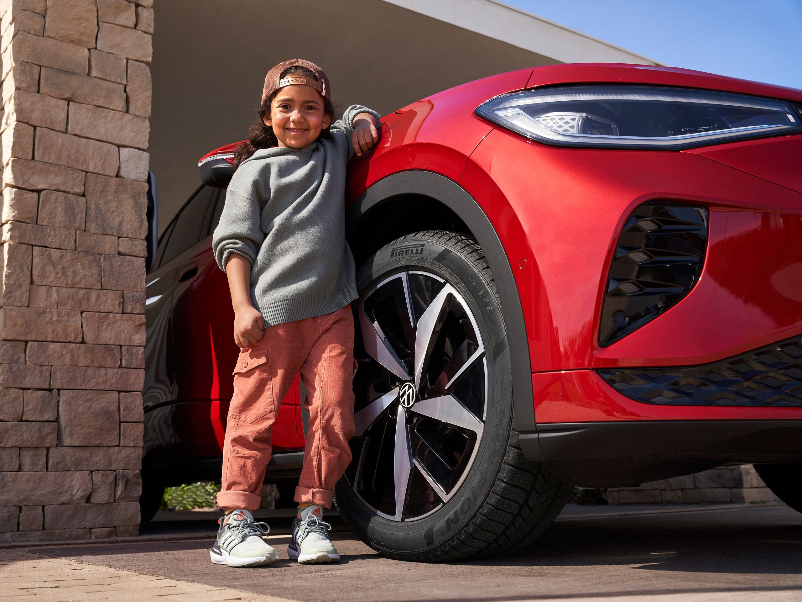 Dievča sa opiera o VW ID.5 GTX, v centre pozornosti sú pneumatiky