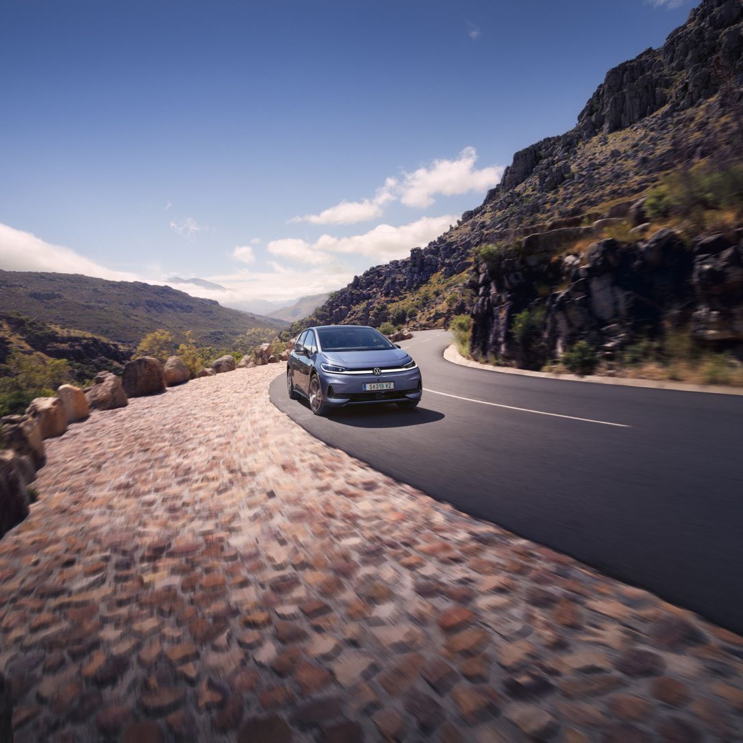 Modrý VW ID.3 Neo jazdí po kľukatej horskej ceste.
