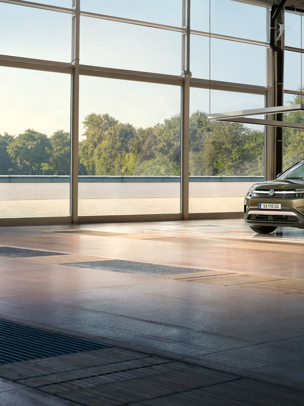 VW ID. Cross je zaparkovaný v minimalistickom dizajnérskom štúdiu, vedľa poskakuje neho nadšený muž a rozpráva sa s inžinierom.