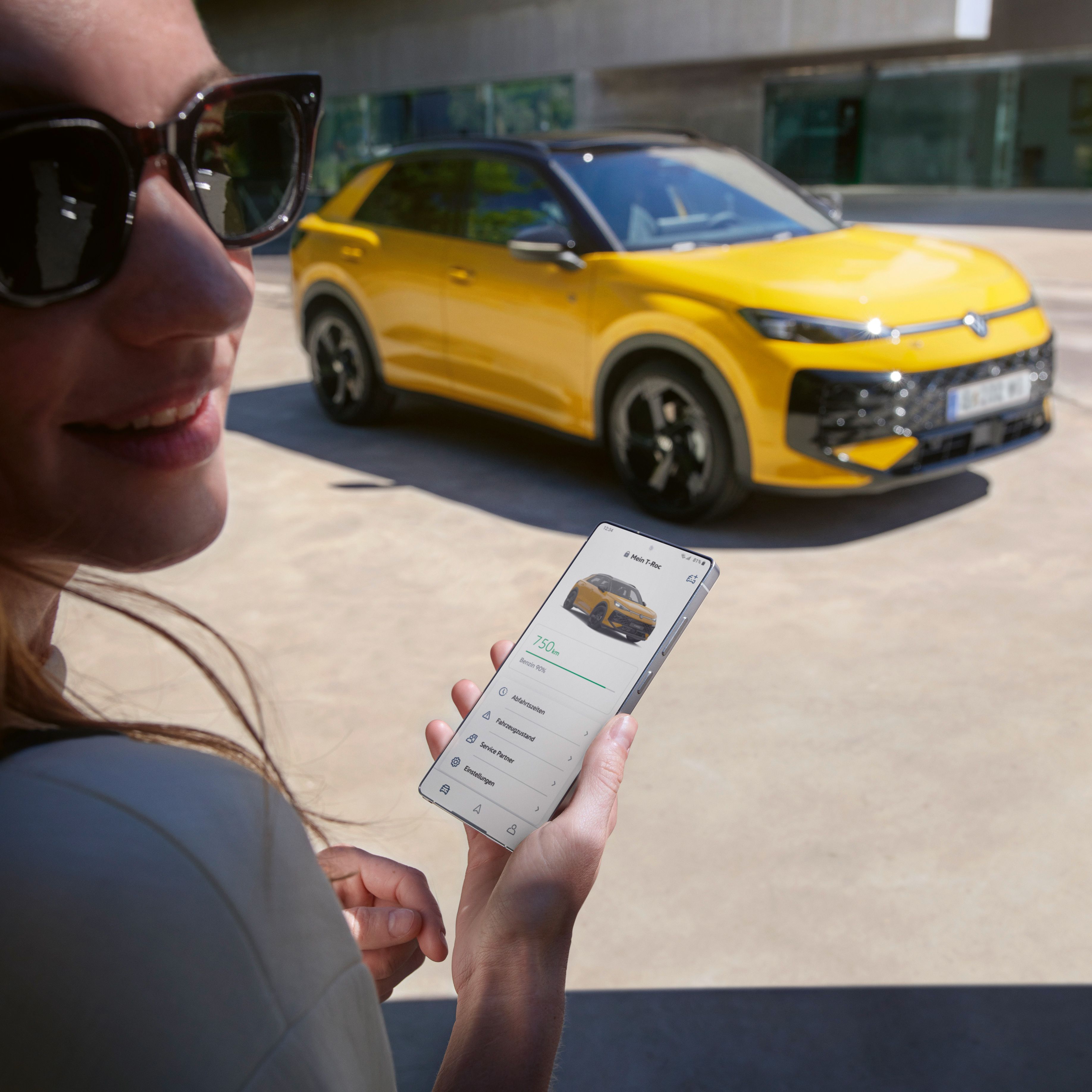 Žena používa aplikáciu VW Connect v blízkosti svojho vozidla VW T-Roc R-Line.