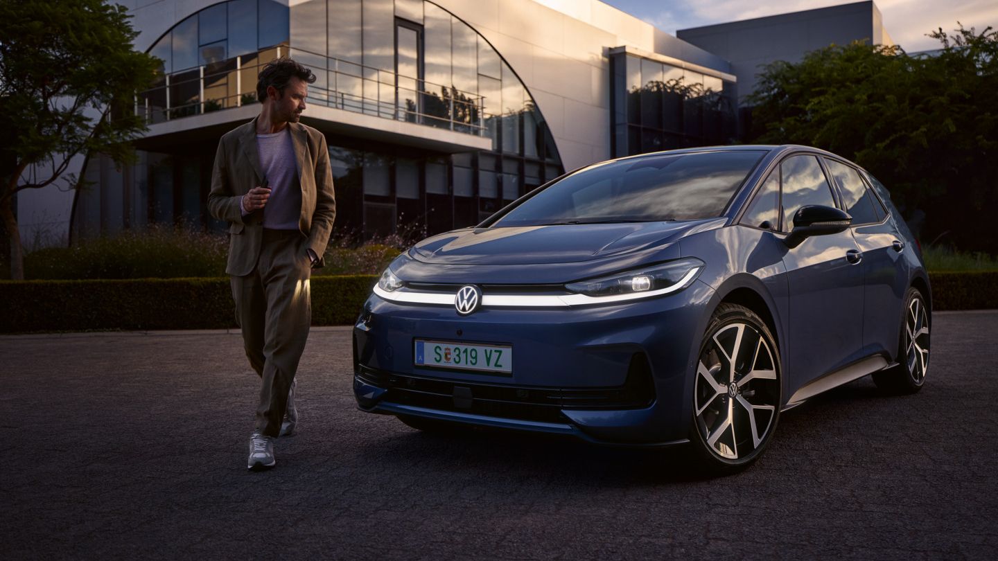 Muž obchádza prednú časť modrého VW ID.3 Neo a obdivuje dizajn osvetlenia