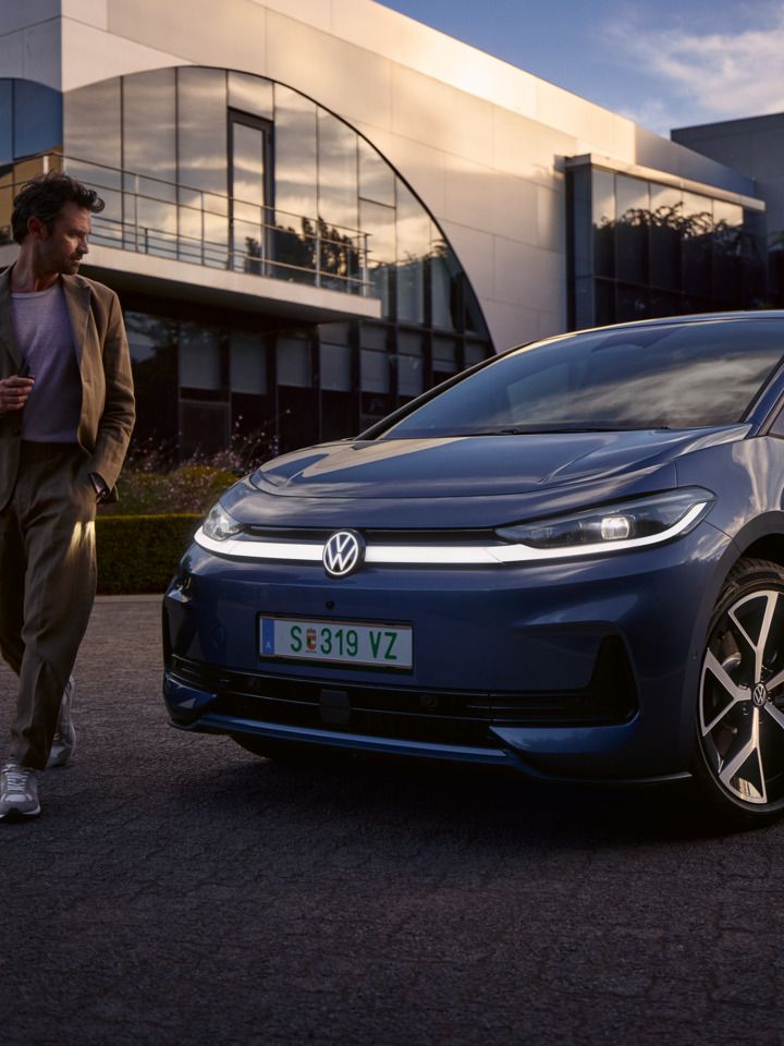 Muž obchádza prednú časť modrého VW ID.3 Neo a obdivuje dizajn osvetlenia